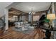 Elegant living room featuring a grand piano, stylish seating, and hardwood floors at 25312 E Glasgow Pl, Aurora, CO 80016
