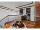 Cozy upstairs reading nook with hardwood floors, a comfortable chair, and custom bookshelves at 25312 E Glasgow Pl, Aurora, CO 80016