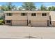 Well-maintained townhouses feature garages, brick accents, and a welcoming facade in a residential neighborhood at 6937 E Girard Ave, Denver, CO 80224