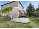 Backyard view with patio, deck, and lush green lawn, perfect for outdoor activities and entertaining at 11007 Meadowvale Cir, Highlands Ranch, CO 80130