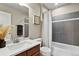 Modern bathroom with stylish fixtures, a sleek vanity, and a shower-tub combination with a patterned curtain at 11007 Meadowvale Cir, Highlands Ranch, CO 80130
