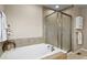 A well-lit bathroom featuring a large soaking tub and a separate glass-enclosed shower at 11007 Meadowvale Cir, Highlands Ranch, CO 80130