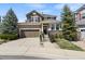 Charming two-story home with a well-manicured lawn and a welcoming entrance, showcasing curb appeal at 11007 Meadowvale Cir, Highlands Ranch, CO 80130