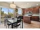 Modern kitchen featuring granite countertops, wood cabinetry, stainless steel appliances, and a stylish island at 11007 Meadowvale Cir, Highlands Ranch, CO 80130