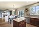 Open-concept kitchen with an island, granite countertops, and a view of the outdoor dining area at 11007 Meadowvale Cir, Highlands Ranch, CO 80130