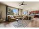 Open-concept living room with a comfortable sectional sofa, fireplace, and view of the adjacent kitchen at 11007 Meadowvale Cir, Highlands Ranch, CO 80130