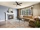 Inviting living room with a stone fireplace, plush sofa, and a large window offering a scenic view at 11007 Meadowvale Cir, Highlands Ranch, CO 80130