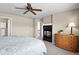 Cozy main bedroom with a fireplace, ceiling fan, and natural light from the window at 11007 Meadowvale Cir, Highlands Ranch, CO 80130