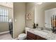 Convenient powder room featuring a granite vanity, modern sink, and adjacent laundry area at 11007 Meadowvale Cir, Highlands Ranch, CO 80130