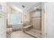 Luxurious bathroom features a soaking tub, glass-enclosed shower, and modern finishes at 2235 Stonecrop Way, Golden, CO 80401