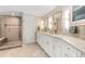 Elegant bathroom features a dual sink vanity, modern fixtures, and glass enclosed shower at 2235 Stonecrop Way, Golden, CO 80401