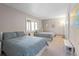 Shared bedroom featuring two beds with patterned blue and white covers, carpet floors, and a window at 2235 Stonecrop Way, Golden, CO 80401