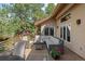 Relaxing deck area with ample seating, wood flooring, and views of the surrounding greenery at 2235 Stonecrop Way, Golden, CO 80401