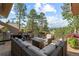 Outdoor deck with plenty of seating around a fire pit and views of the surrounding mountains and trees at 2235 Stonecrop Way, Golden, CO 80401