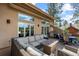 Spacious outdoor deck features a seating area and table for dining while enjoying mountain views at 2235 Stonecrop Way, Golden, CO 80401