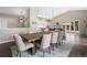 An open dining area with a chandelier and bar seating. The hardwood floor adds an elegant look to the room at 2235 Stonecrop Way, Golden, CO 80401