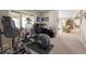 Carpeted home gym and office space featuring an elliptical, treadmill, weights, and a desk with a computer at 2235 Stonecrop Way, Golden, CO 80401