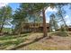 Multi-level home surrounded by lush trees, offering privacy and a serene atmosphere at 2235 Stonecrop Way, Golden, CO 80401