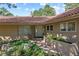 Inviting front entrance with tiled roof, glass block window, and attractive landscaping with greenery and stone accents at 2235 Stonecrop Way, Golden, CO 80401