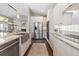 Well-equipped kitchen featuring modern appliances, stone countertops, ample storage, and stylish lighting at 2235 Stonecrop Way, Golden, CO 80401