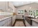 Bright kitchen featuring stone countertops, stainless steel appliances, a modern sink, and under-cabinet lighting at 2235 Stonecrop Way, Golden, CO 80401