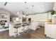 Spacious kitchen featuring stone countertops, a center island with seating, and stainless steel appliances at 2235 Stonecrop Way, Golden, CO 80401