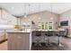 Bright, updated kitchen with stone countertops, modern pendant lighting, stainless steel appliances, and hardwood floors at 2235 Stonecrop Way, Golden, CO 80401