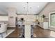 Open-concept kitchen featuring a large island with bar seating, stainless steel appliances, and sleek modern design at 2235 Stonecrop Way, Golden, CO 80401