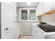 Well-lit laundry room featuring modern appliances, ample storage, and a convenient layout at 2235 Stonecrop Way, Golden, CO 80401