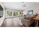An open living room features hardwood floors, a vaulted ceiling, a fireplace, and large windows with scenic views at 2235 Stonecrop Way, Golden, CO 80401