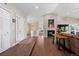An open living area features hardwood floors, a vaulted ceiling, a fireplace, and leads to other areas of the home at 2235 Stonecrop Way, Golden, CO 80401
