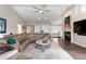 Spacious living room with hardwood floors, a vaulted ceiling, and a fireplace in an open concept layout at 2235 Stonecrop Way, Golden, CO 80401