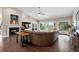 A spacious living room features hardwood floors, a vaulted ceiling, a fireplace, and large windows with scenic views at 2235 Stonecrop Way, Golden, CO 80401