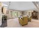Inviting living room featuring a fireplace, neutral carpet, and sliding doors with views of lush trees at 2235 Stonecrop Way, Golden, CO 80401