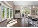 Bright living space featuring hardwood floors, bar seating, and large windows with an outdoor view at 2235 Stonecrop Way, Golden, CO 80401