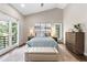 Serene main bedroom with balcony access, vaulted ceilings, and mountain views at 2235 Stonecrop Way, Golden, CO 80401