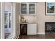 The wet bar area includes a wine fridge and storage; all next to a sliding door that leads outside at 2235 Stonecrop Way, Golden, CO 80401