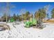 Community playground with play structures and slides in winter setting at 25325 E Park Crescent Dr, Aurora, CO 80016