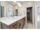 Primary bathroom featuring double vanity, quartz countertop, and mirrors and closet at 1727 W 166Th Ave, Broomfield, CO 80023