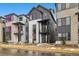 Striking two-story modern home with black and white exterior, a small balcony, and neat landscaping at 1727 W 166Th Ave, Broomfield, CO 80023