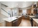 Modern kitchen with island, stainless steel range hood, cabinets, countertops, backsplash, and modern appliances at 1727 W 166Th Ave, Broomfield, CO 80023