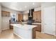 Modern kitchen with an island, quartz countertops, stainless steel appliances, and hardwood floors at 1727 W 166Th Ave, Broomfield, CO 80023