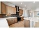 Modern kitchen with island, stainless steel range hood, cabinets, countertops, backsplash, and modern appliances at 1727 W 166Th Ave, Broomfield, CO 80023