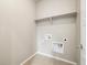 A utility room with a shelf, washer and dryer hookups, and tile flooring at 1727 W 166Th Ave, Broomfield, CO 80023