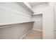 A walk-in closet with shelving and a rod for hanging clothes and beige carpet at 1727 W 166Th Ave, Broomfield, CO 80023