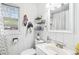 Bright bathroom featuring beadboard, window, and a pedestal sink at 11827 Brook Rd, Golden, CO 80403
