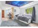 This bedroom features a unique celestial ceiling and convenient access to the adjacent kitchenette at 11827 Brook Rd, Golden, CO 80403