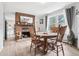 Charming dining room features a fireplace, wooden table with chairs, wood floors, and natural light from a nearby window at 11827 Brook Rd, Golden, CO 80403
