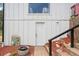Exterior view of the home's back entrance with a brick walkway and decorative mirror at 11827 Brook Rd, Golden, CO 80403