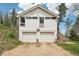 The front of the property features a two-car garage under the main structure of the home at 11827 Brook Rd, Golden, CO 80403